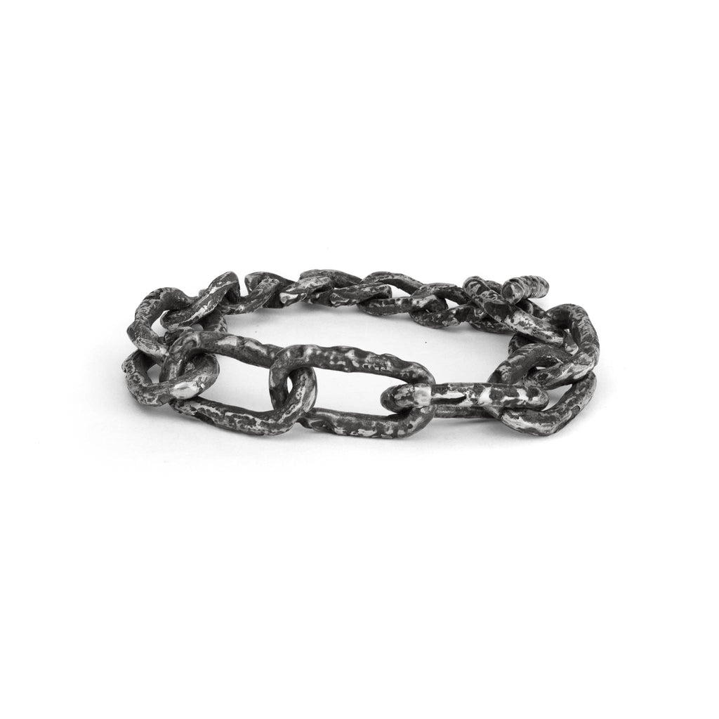 Sterling silver chain link bracelet with big links and a raw texture on a white background made in our Berlin jewelry studio.