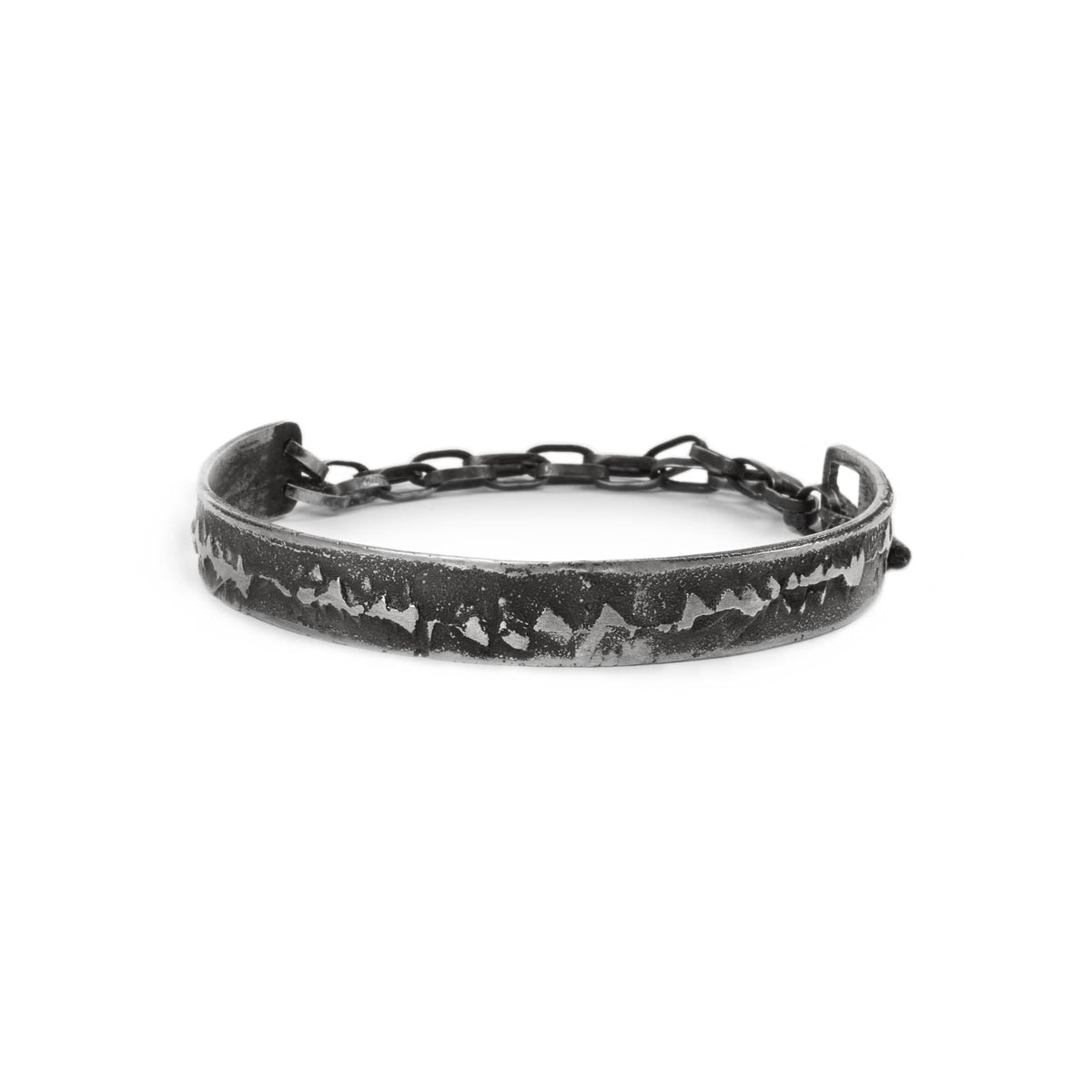 Silver cuff bracelet with texture and chain on a white background made in Berlin