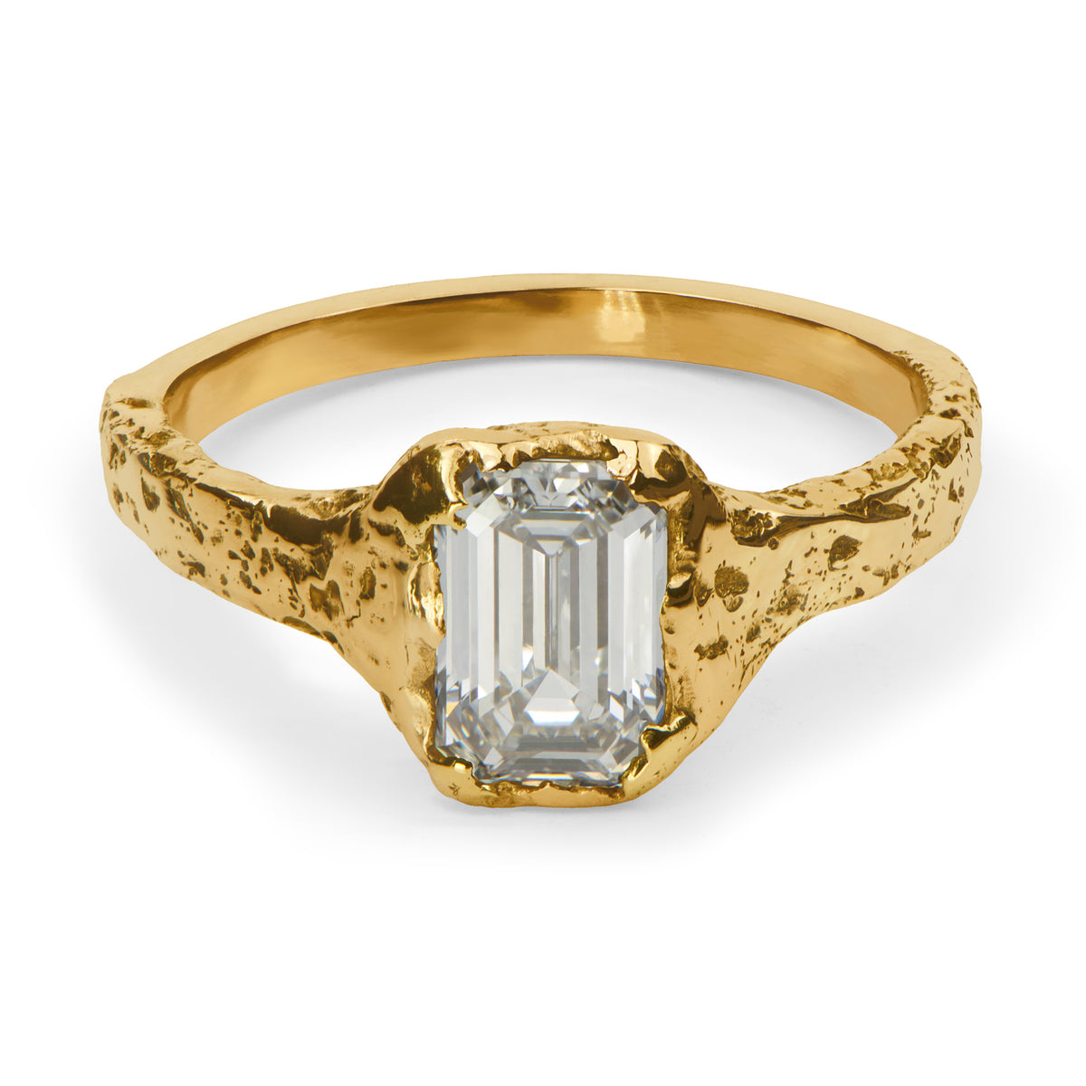 Gold ring with a rectangular diamond on a white background