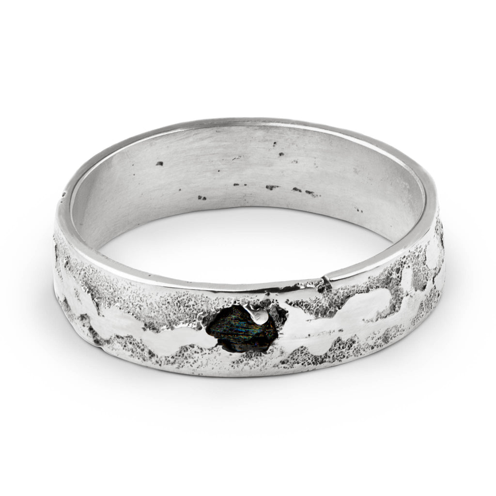 Handcrafted sterling silver ring with a black moissanite set in a 6mm textured band b Berlin jewelry studio.