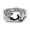 Oxidised sterling silver signet ring with raw textured 8 x 12 mm top handmade in Berlin laying on a white surface.