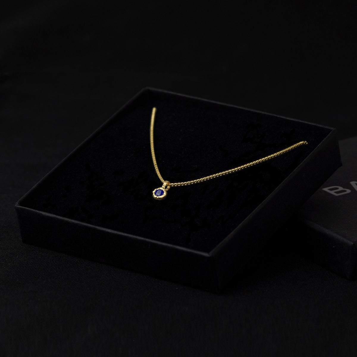 Gold Charm Necklace With Blue Sapphire