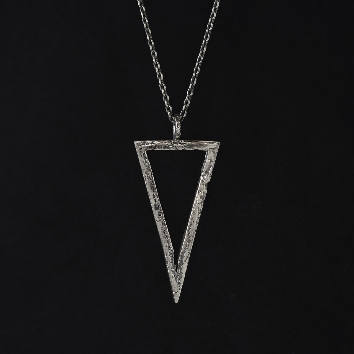 Handcrafted sterling silver triangle pendant necklace with an organic textured geometric design